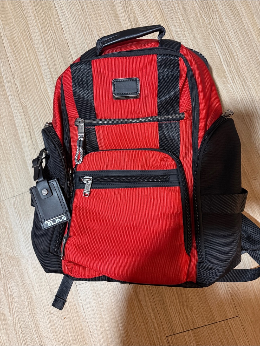 Tumi Red and Black Men/Women’s Backpack with Multiple Front Pockets